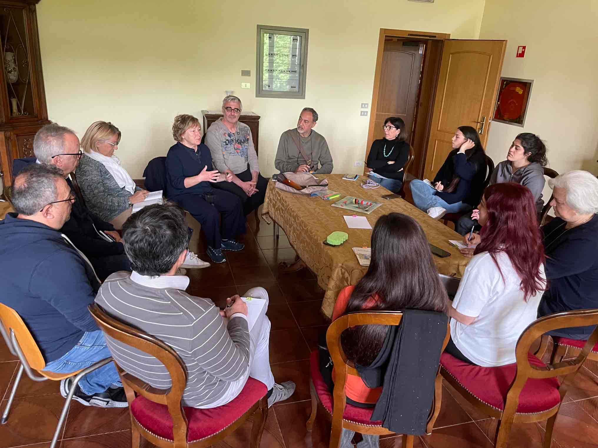 Group of people around a table talking and reflecting